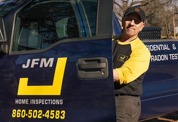 Jay McNulty, professional home inspector, standing with his truck after a home inspection.